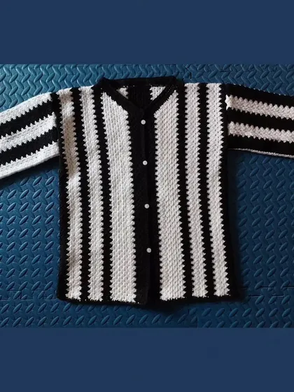 A flat-lay of the striped shirt, showing the clean construction and even stitching.