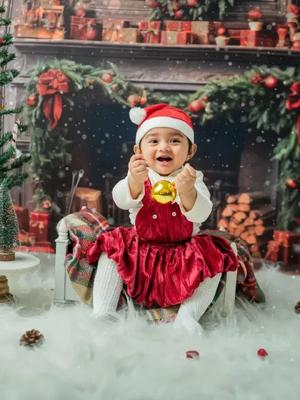 A big, joyful laugh while holding a shiny gold ornament. This is the kind of infectious happiness I love to capture.