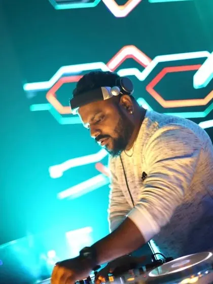 A close-up shot of me mixing under the vibrant neon lights of a club. This captures my "work hard, play hard" philosophy in a single frame.