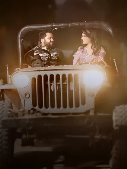 A dramatic, softly focused shot of a couple inside the vintage jeep at dusk. This image has a classic, cinematic feel, perfect for a romantic pre-wedding album.