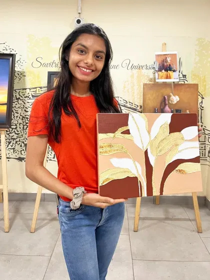 A student in my Pune studio proudly displays her modern, textured painting featuring stylized leaves in earthy tones with gold leaf accents.