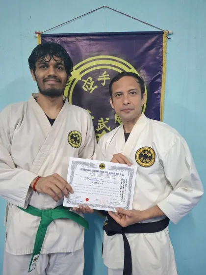An adult student is awarded his 4th Kyu (green belt). It is never too late to begin the journey of martial arts for self-defense and character development.