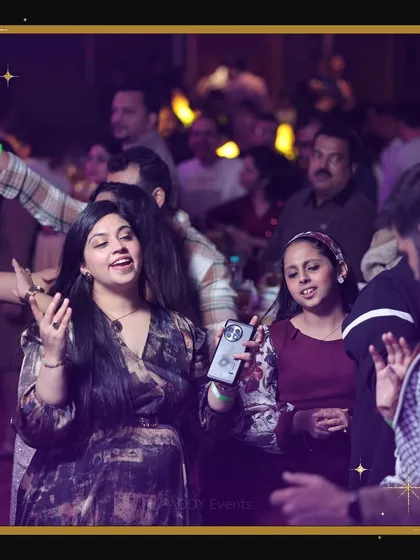 Guests singing and dancing along at a corporate New Year's Eve party. This photo highlights the engaging and festive atmosphere that encourages participation and enjoyment.