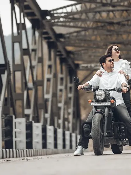 This shot captures the feeling of hitting the open road together. The low angle and the couple looking ahead create a sense of shared adventure and looking towards the future.