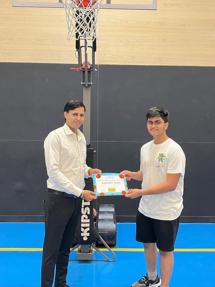 Another player receives his certificate, marking the successful completion of our summer camp program.