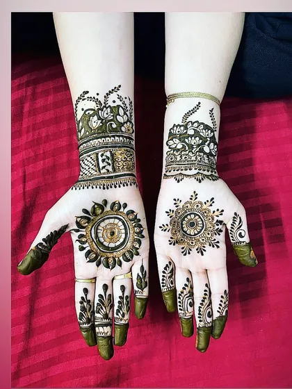 A lovely combination of mandala art on the palms and lotus cuffs on the wrists. This design blends traditional symbols with a modern, spaced-out application.