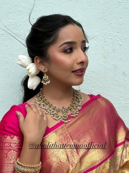 Another angle of this radiant Diwali look, highlighting the classic hairstyle with fresh white flowers.