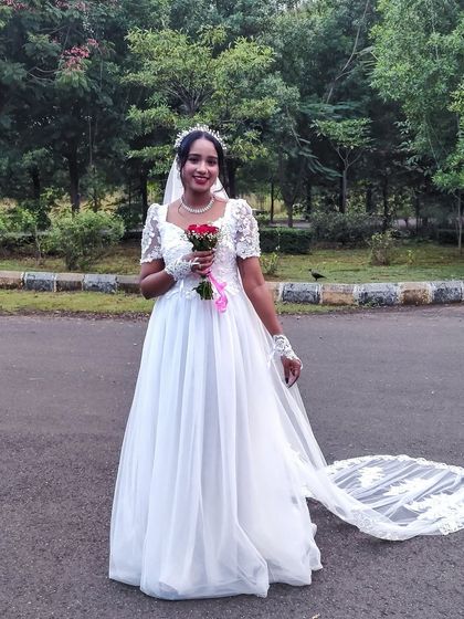 A happy Christian bride on her wedding day in a beautiful white gown from my collection. Gowns start at just ₹1500.