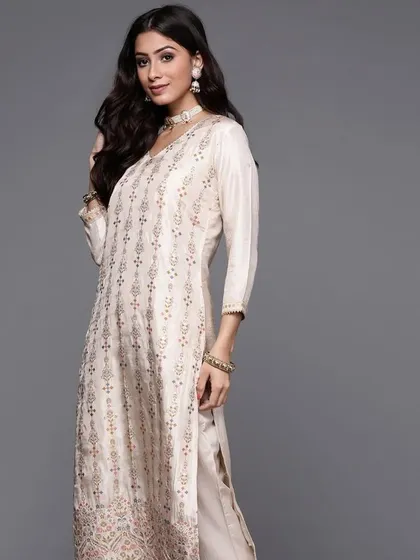 A cream kurta pant set with jacquard woven work. The subtle texture and elegant design make it a sophisticated choice for any occasion.