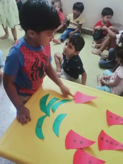 A moment from our Summer Fun Fest, where children learn about shapes and letters through a fun watermelon craft activity.