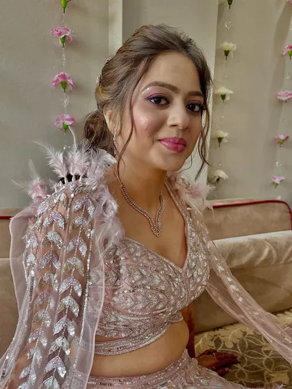 This bride's reception look is a balance of playful hues and refined elegance, with shimmering lids and a radiant glow.