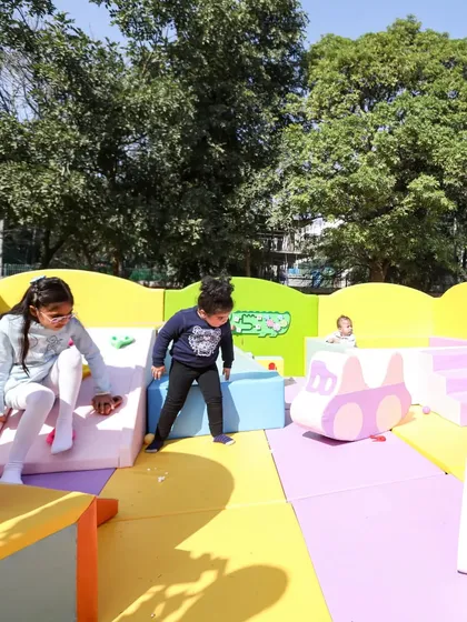 So much to do! This shot captures multiple children engaged in different activities within the same play zone.