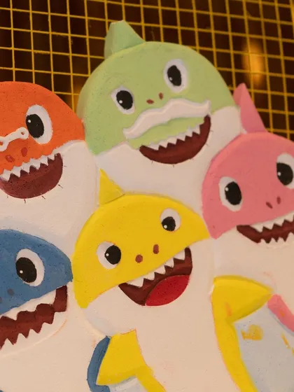 A close-up of the hand-crafted Baby Shark family props, a key element in bringing the popular theme to life.
