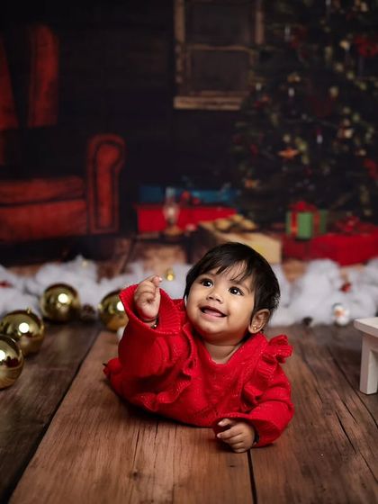 This little one is reaching for the stars, or maybe just a Christmas ornament. A lovely candid moment from the holiday shoot.