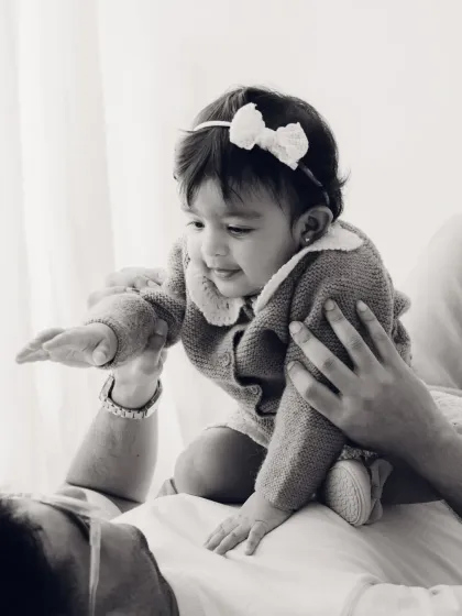 A playful moment between a father and his baby, captured in timeless black and white.
