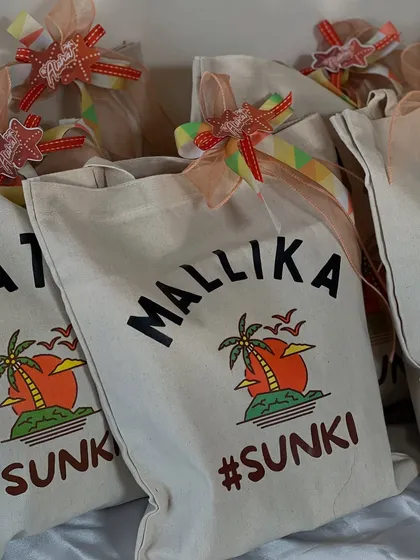 A lineup of personalized tote bags for the #SUNKI beach bachelorette party. Each bag features the guest's name, making it a special and practical keepsake from the celebration.