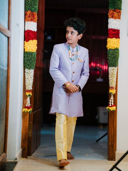 A picture-perfect family celebrating their housewarming. I had the pleasure of dressing my client Archana in a hand-worked blouse, her husband in a custom shirt, and their son in a charming Kalamkari kurta.