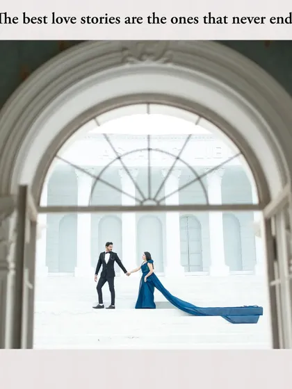 A creatively framed shot of the couple through an archway, adding depth and a storytelling element to the portrait.