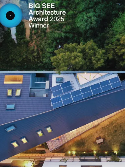 An aerial view of the Chromatic House, which won the BIG SEE Architecture Award 2025. The design showcases a distinctive roof profile with integrated solar panels and skylights, highlighting our focus on sustainable residential architecture.