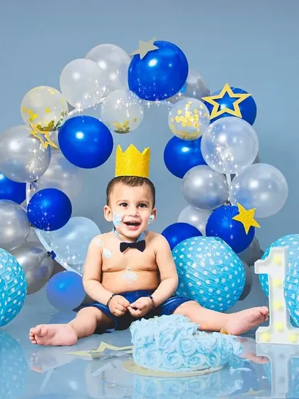 Nothing says "birthday" like a cake smash! We love capturing the pure, messy fun as little ones dive into their first taste of cake. This blue-themed setup shows a classic, happy cake smash moment.