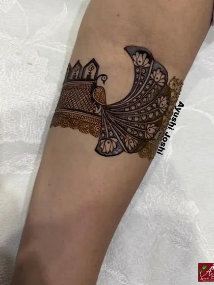The initial stage of the 'Varshitap' armband, featuring a graceful peacock with a flowing tail.