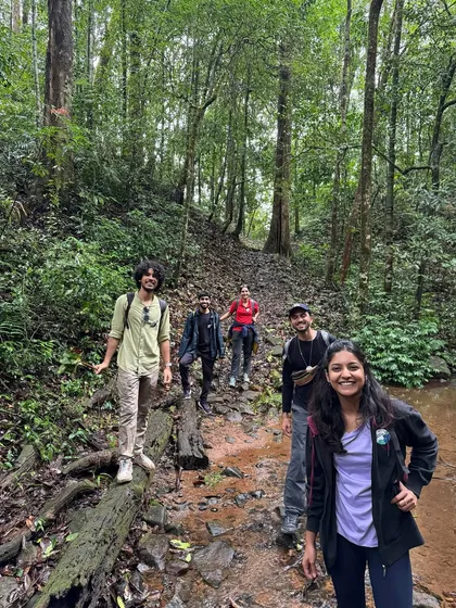 Happy trekkers making their way through a forest stream on the Kumara Parvatha trail.
