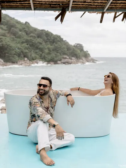 A fun and relaxed moment of Komal and Akhil by an outdoor bathtub overlooking the Phuket sea.
