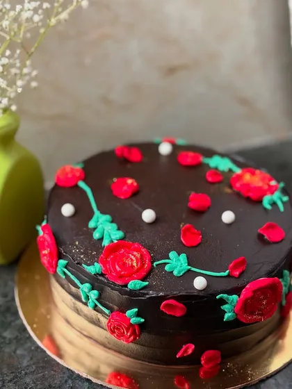 A closer view of the piped roses on the Dutch truffle cake, showing the detail of the buttercream art.