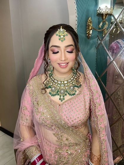 A close-up of the bride's makeup with her eyes closed, showing the delicate pink eyeshadow.