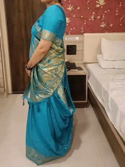 A side profile of the draped Gujarati style saree. Our pre-pleating service ensures the fit is comfortable and the silhouette is flattering from every angle.
