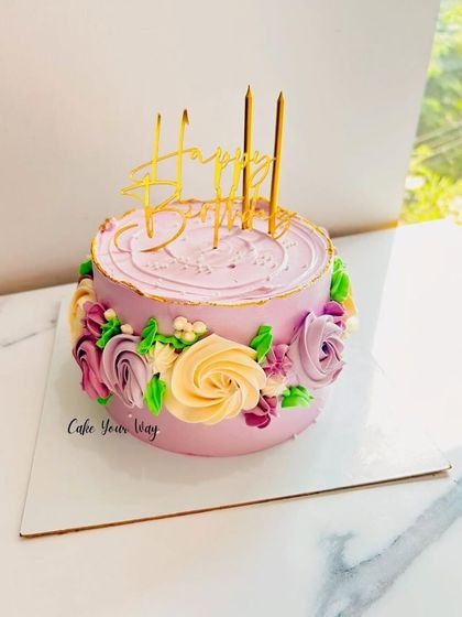 This one’s a whole mood. A pretty lavender cake with a wreath of colorful buttercream flowers.