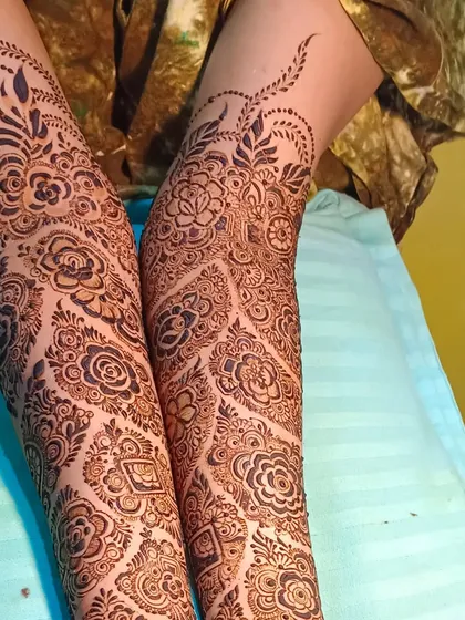 A full arm design with a focus on floral patterns, showing how a bridal mehendi can be intricate without being overpowering.