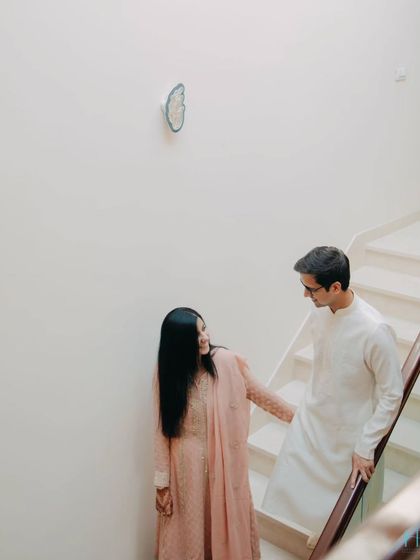 A minimalist composition using the clean lines of a modern staircase. This shot shows how we can turn everyday spaces into the backdrop for a beautiful, understated love story.