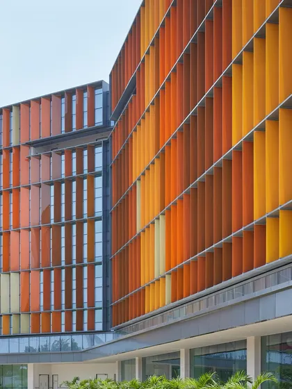 The vibrant, multi-coloured fins of the Infosys Nagpur campus are a defining feature of the project. They are a testament to how functional elements, like solar shading, can also become the primary aesthetic expression of a building.