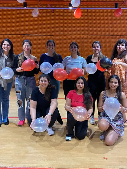 Our ladies' group posing with balloons during a celebration. Every day is a reason to celebrate at Zink.