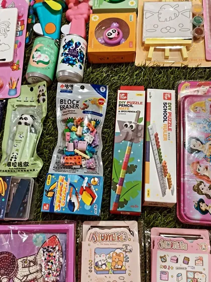 I make sure to stock a variety of puzzle pencils, block erasers, and themed stationery cases. This image highlights some of the unique and engaging school supplies that work well as party favors.