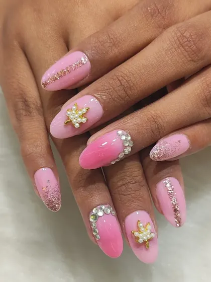 This angle highlights the glitter accent nails and the delicate sparkle throughout the pink ombre bridal set.