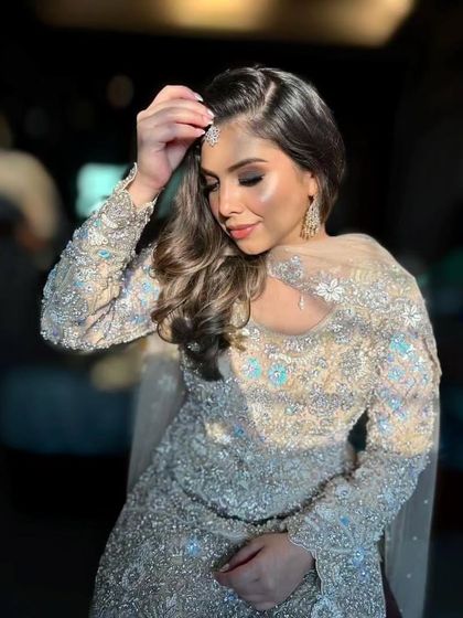 A sophisticated and elegant party look. The shimmering silver outfit is paired with a soft smokey eye and contoured features.