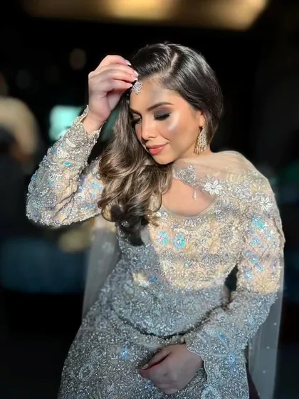 A sophisticated and elegant party look. The shimmering silver outfit is paired with a soft smokey eye and contoured features.