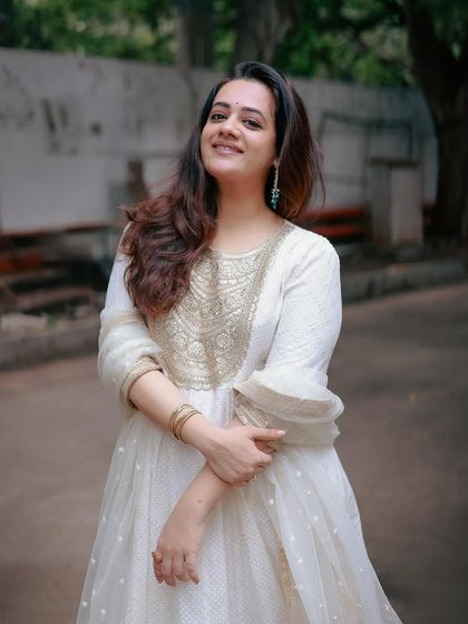 A happy, candid shot of Spruha Varad, looking radiant in the elegant white ensemble.