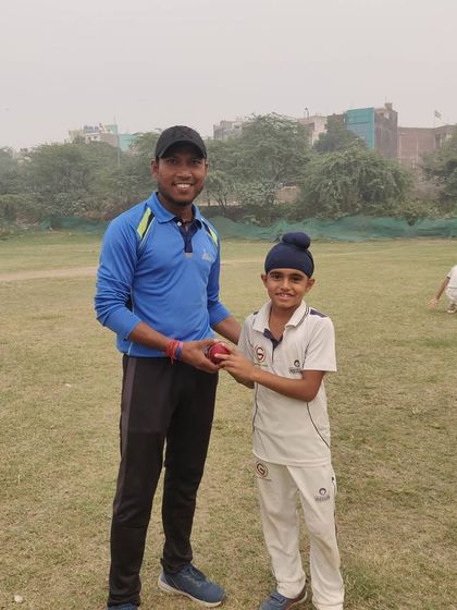 A senior player giving tips to young Samraj after he took 5 wickets. This mentorship culture helps everyone grow.