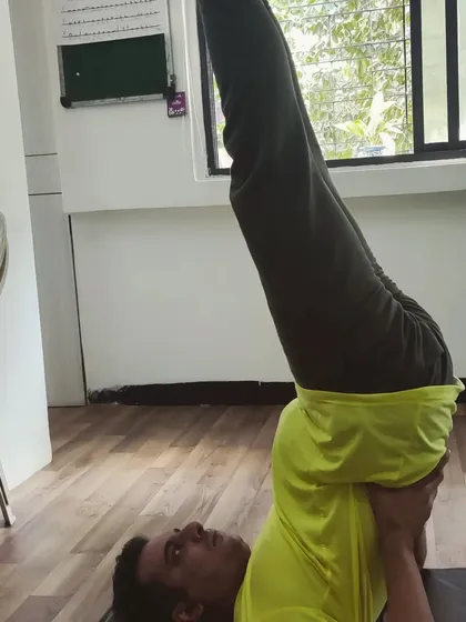 In Sarvangasana, the key is to support the body's weight on the shoulders, not the neck. My guidance ensures students practice this beneficial inversion safely and effectively.