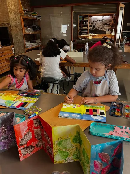 In our artist's book making camps, we combine printmaking, drawing, and storytelling. Here, young creators are completely absorbed in filling their handmade accordion books with their own unique worlds and narratives.