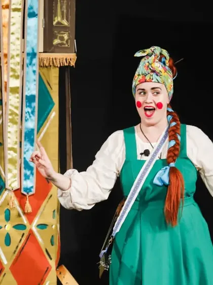 A performer from the Russian show 'Petrushka' interacts with the audience. The show combines live acting with traditional hand puppetry for a slap-happy celebration of Russia's most famous puppet character.