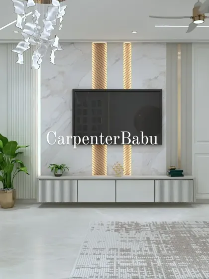 A modern TV unit with a marble back panel and gold-accented fluted columns. The abstract chandelier adds a sculptural element to this elegant living room.