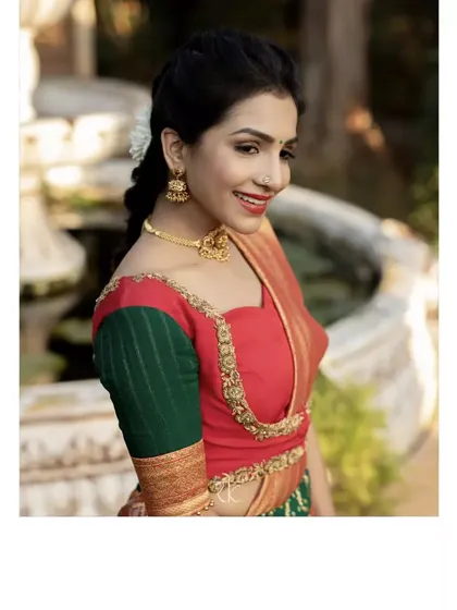 A smiling portrait in the brocade bandhini drape skirt and dual-toned blouse. The golden bead embroidery along the neckline adds a touch of festive shimmer.