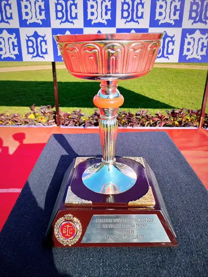 The Vidhana Soudha Trophy, a classic cup with a warm, reddish hue.