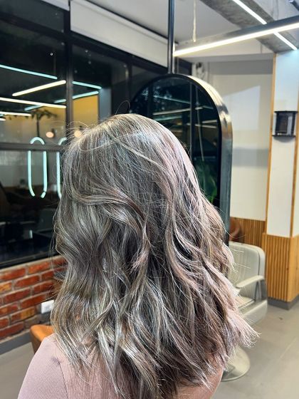 A combination of ash blonde babylights and a layered cut. This creates a soft, textured look with beautiful, subtle dimension.
