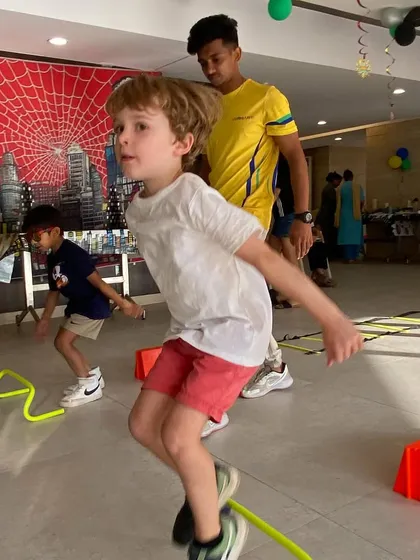 A child jumps over hurdles inside a party hall. Our lightweight, safe equipment is perfect for creating an exciting obstacle course anywhere.