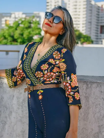 A full view of the floral jumpsuit, showing off the beautiful embroidery and flattering silhouette.